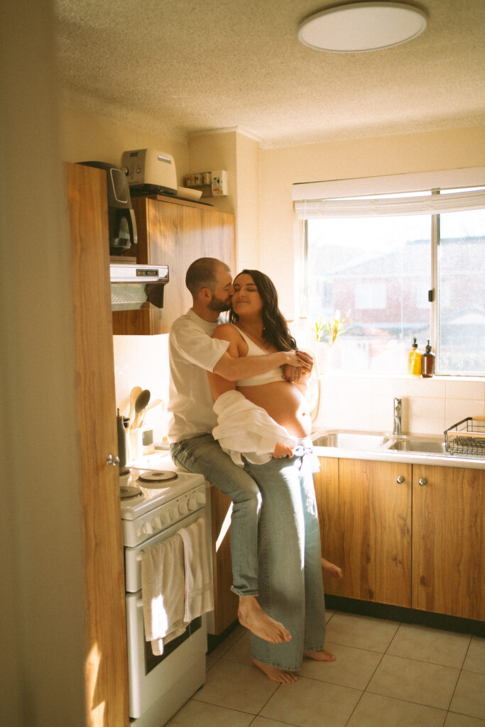 Expectant couple having tea during an in-home maternity photoshoot