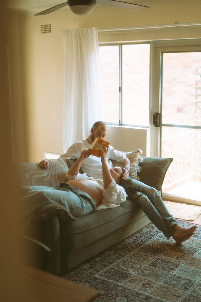 Expectant couple having tea during an in-home maternity photoshoot