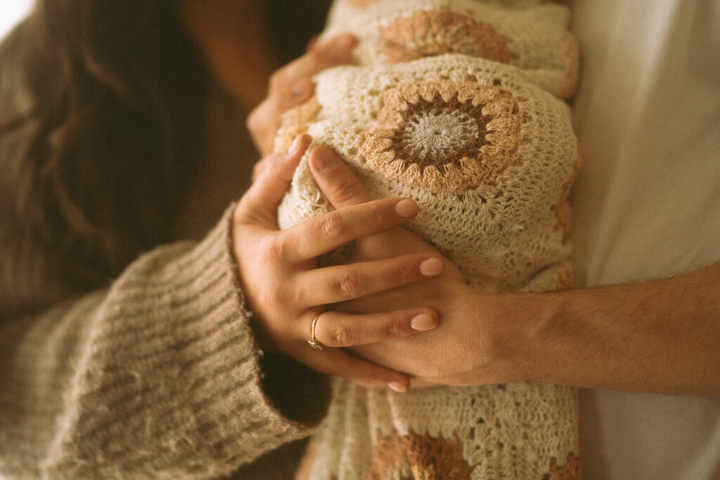 Ella and Tom with their baby for lifestyle newborn photos.