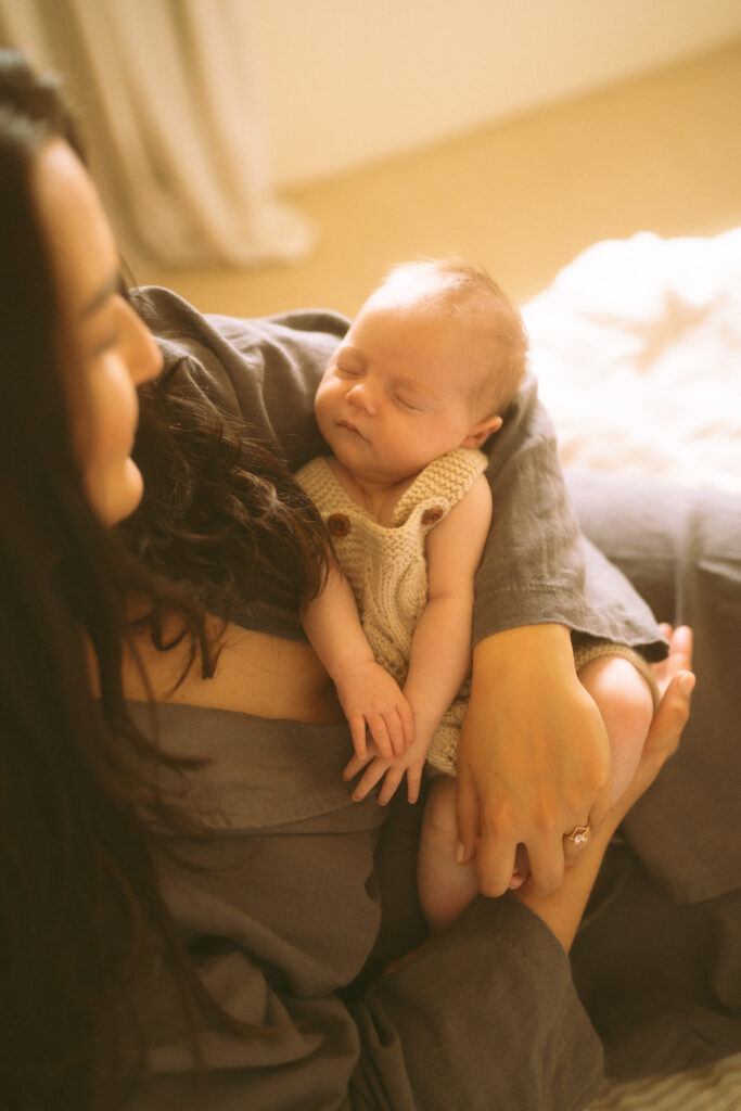 Mother looking lovingly at newborn baby.