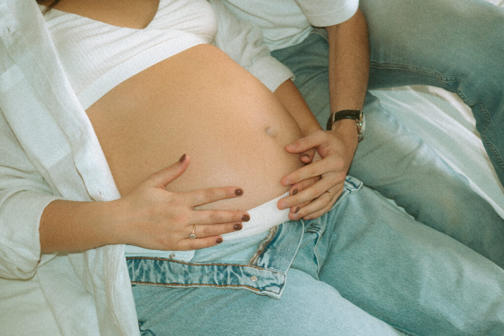 Expectant couple having tea during an in-home maternity photoshoot