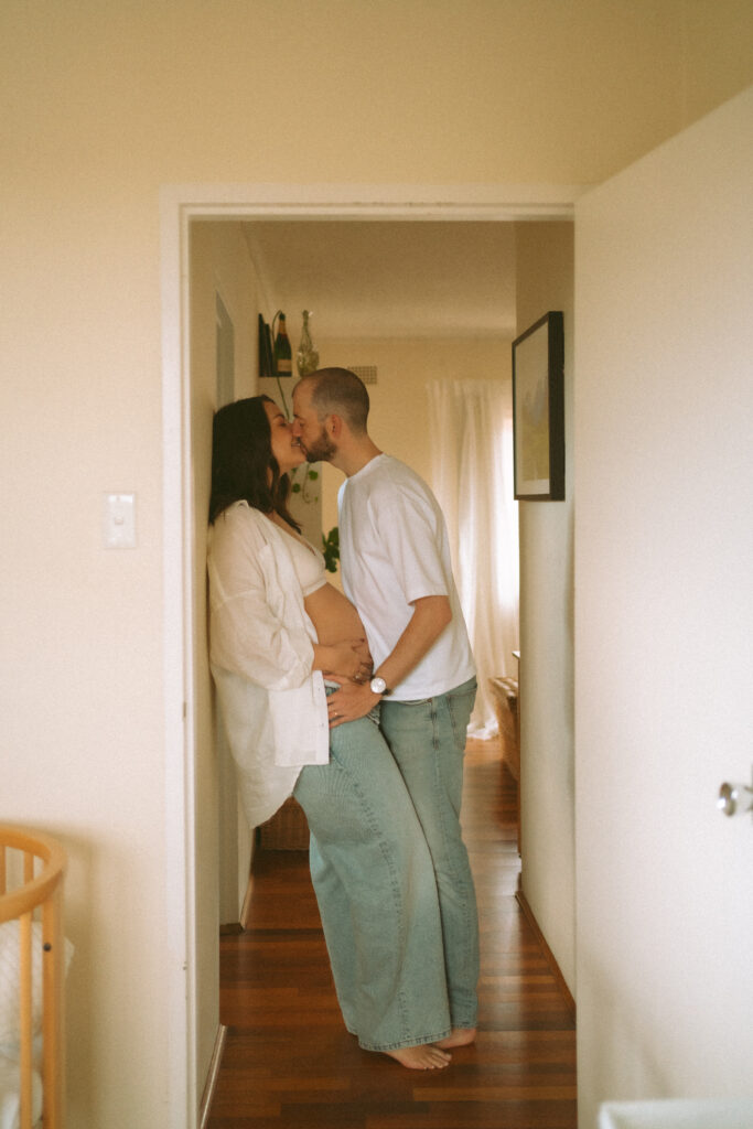 Expectant couple having tea during an in-home maternity photoshoot