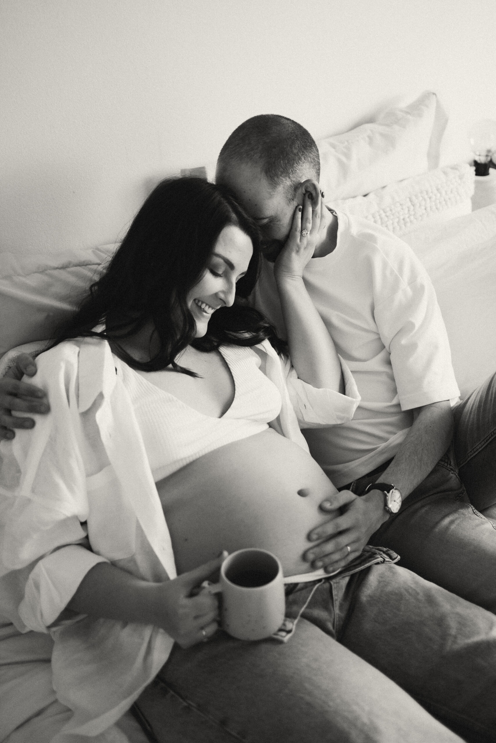 Expectant couple having tea during an in-home maternity photoshoot