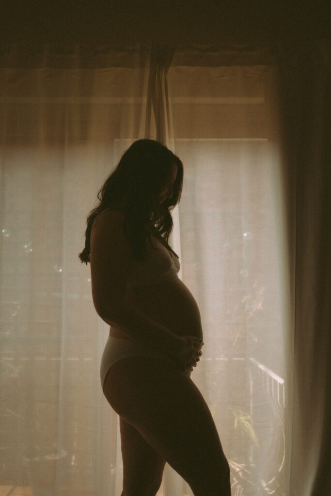Expectant couple having tea during an in-home maternity photoshoot
