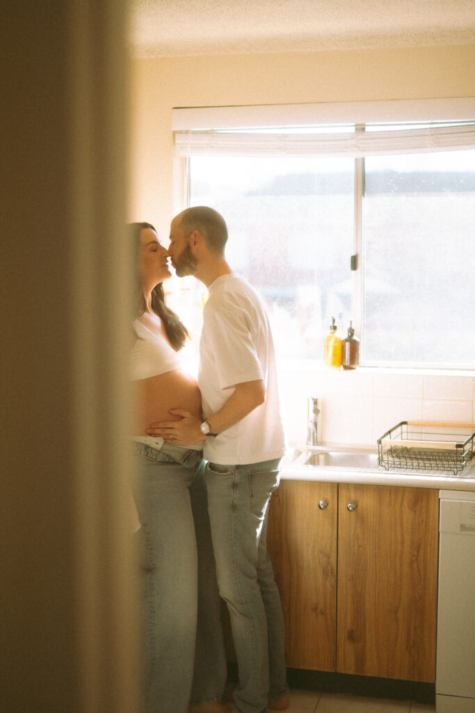 Expectant couple having tea during an in-home maternity photoshoot