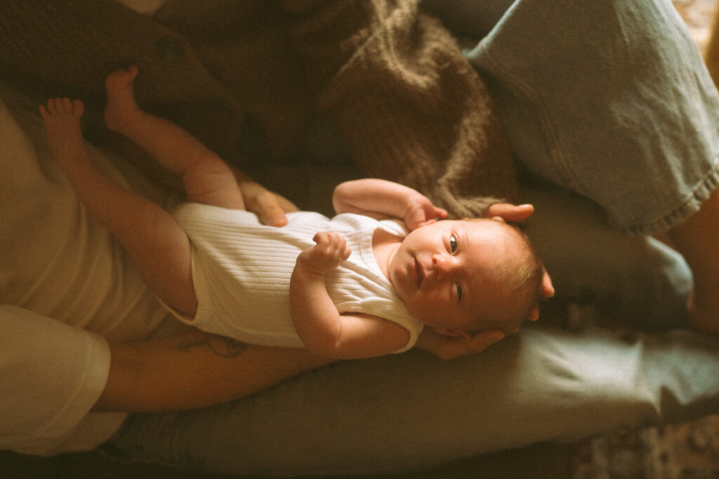 Close up of a newborn baby and cardigan