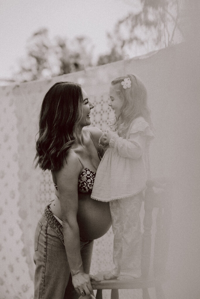 Mother looking at her toddler during a By Joey Motherhood Mini session.